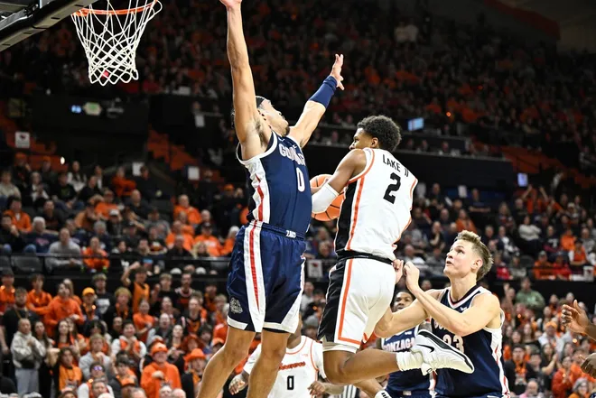 Jan 16, 2025; Corvallis, Oregon, USA; Oregon State Beavers guard Josiah Lake II (2) drives to the basket against Gonzaga Bulldogs guard Ryan Nembhard (0) during the first half at Gill Coliseum.