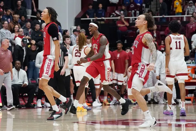 Dec 7, 2025; Stanford, California, USA; UNLV Runnin' Rebels forward Tyrin Jones (6), center Emmanuel Stephen (34), and guard Dra Gibbs-Lawhorn (0) celebrate at the end of the game against as Stanford Cardinal guard Ryan Agarwal (11) and the Stanford Cardinal leave the court at Maples Pavilion.