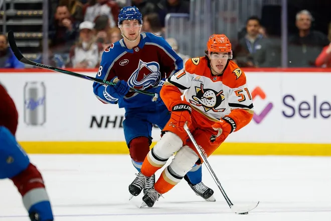 Jan 21, 2026; Denver, Colorado, USA; Anaheim Ducks defenseman Olen Zellweger (51) controls the puck ahead of Colorado Avalanche center Martin Necas (88) in the third period at Ball Arena.