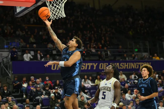 Dec 22, 2025; Seattle, Washington, USA; San Diego Toreros guard Adrian McIntyre (2) shoots a layup against the Washington Huskies during the second half at Alaska Airlines Arena at Hec Edmundson Pavilion.