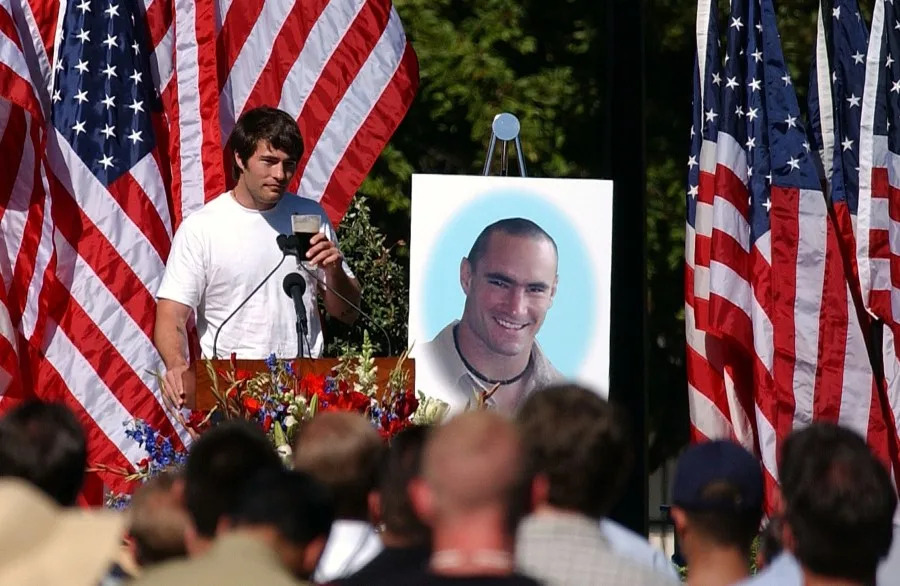 Richard Tillman, the brother of Pat Tillman, raises a glass of Guiness beer as he speaks at a memorial service for his brother on May 3, 2004 in San Jose. (Photo by David Paul Morris /Getty Images)