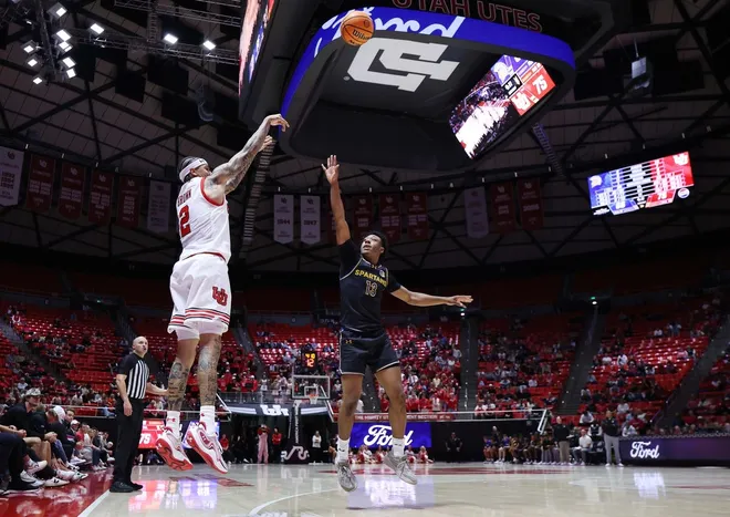 Nov 3, 2025; Salt Lake City, Utah, USA; Utah Utes guard Terrence Brown (2) shoots over San Jose State Spartans guard Jermaine Washington (13) during the second half at Jon M. Huntsman Center.
