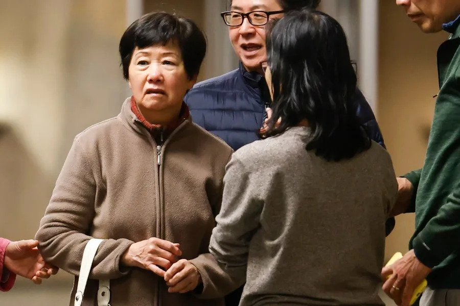 Mary Fong Lau, left, stands with friends in the hallway ahead of a hearing at the Hall of Justice in San Francisco, California Friday, Feb. 13, 2026. Lau is a San Francisco resident facing felony vehicular manslaughter charges in an accident that killed a family of four in March 2024. (Photo by Jessica Christian/San Francisco Chronicle via Getty Images)