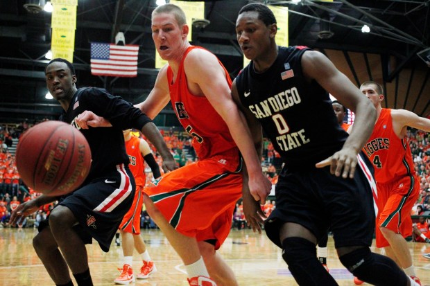 Colorado State center Colton Iverson, center, joins San Diego State guard Jamaal Franklin, left, and forward Skylar Spencer in pursuing a loose ball in the second half of Colorado State's 66-60 victory in an NCAA college basketball game in Fort Collins, Colo., Wednesday, Feb. 13, 2013. (AP Photo/David Zalubowski)