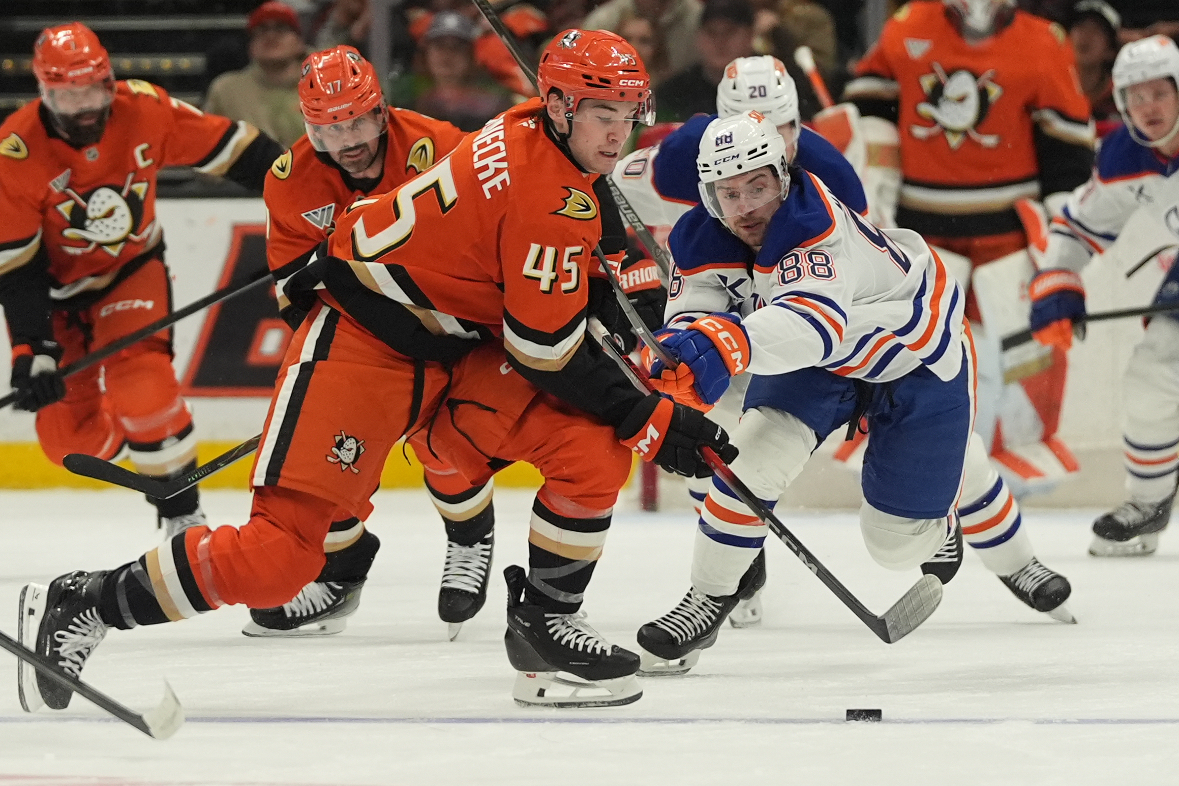 Ducks right wing Beckett Sennecke, left, battles Edmonton Oilers left...