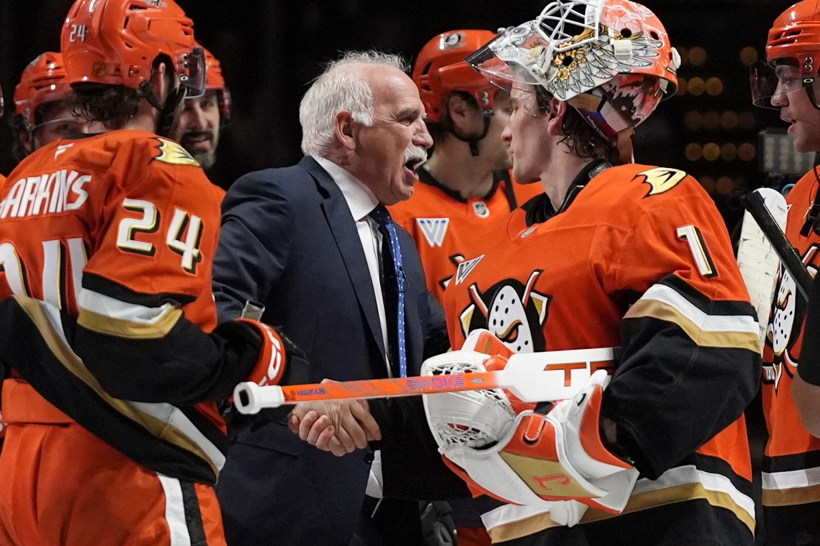 Ducks head coach Joel Quenneville, center, celebrates with goaltender Lukas...