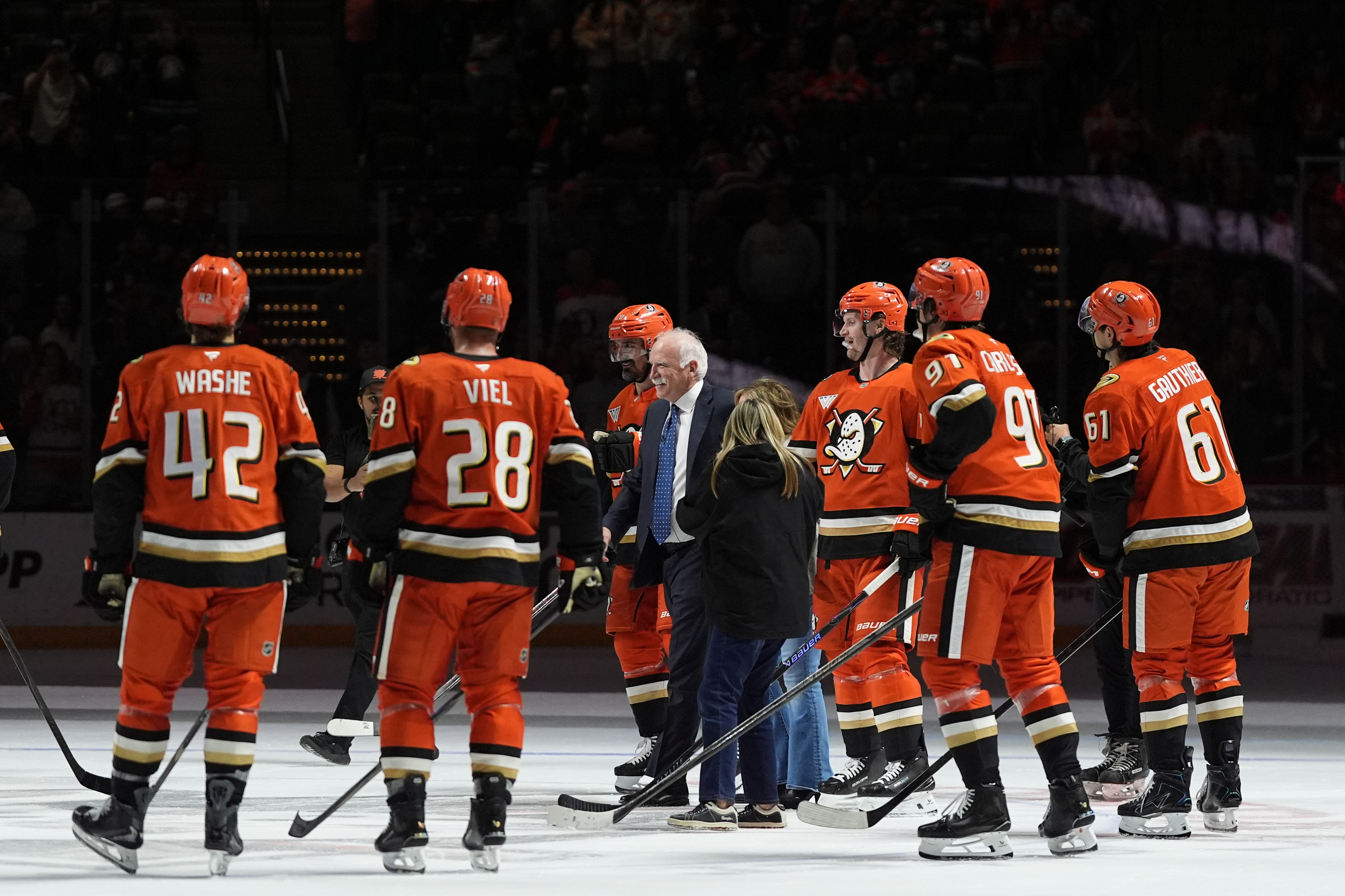 Ducks head coach Joel Quenneville, center, celebrates with players and...