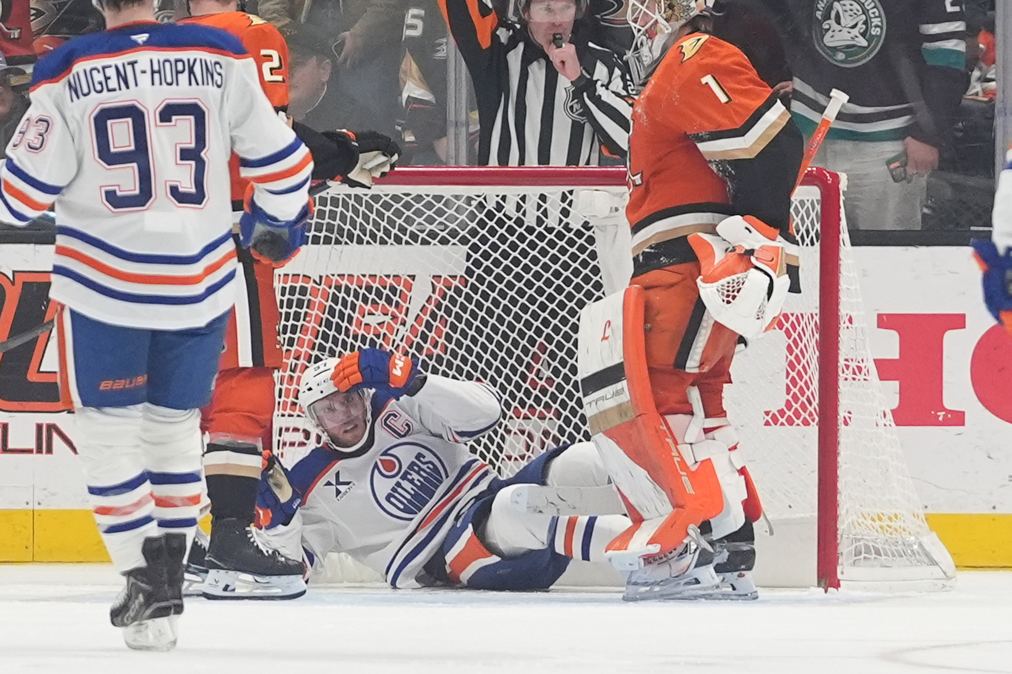 Edmonton Oilers center Connor McDavid takes a moment after crashing...