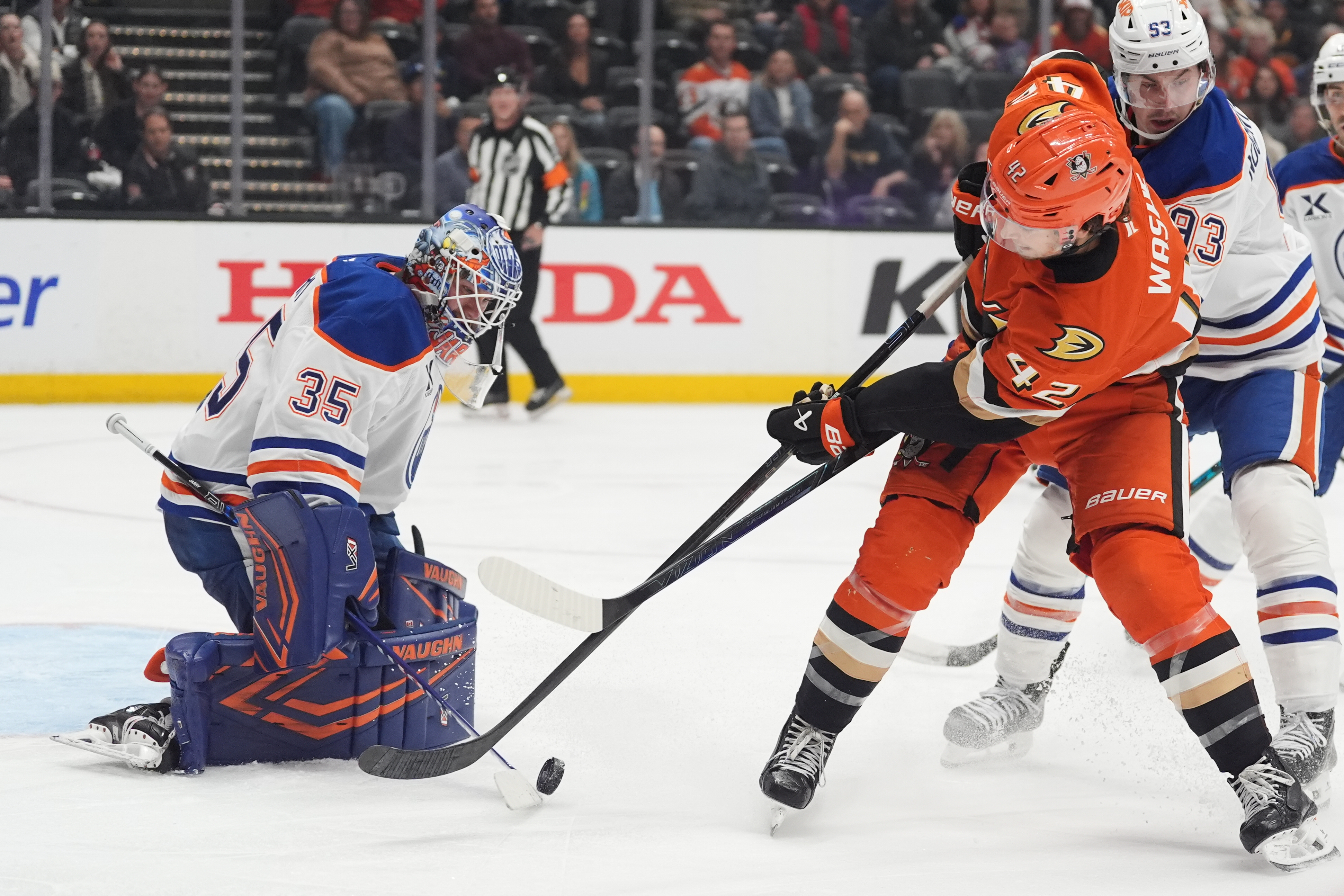 Edmonton Oilers goaltender Tristan Jarry, left, blocks a shot by...