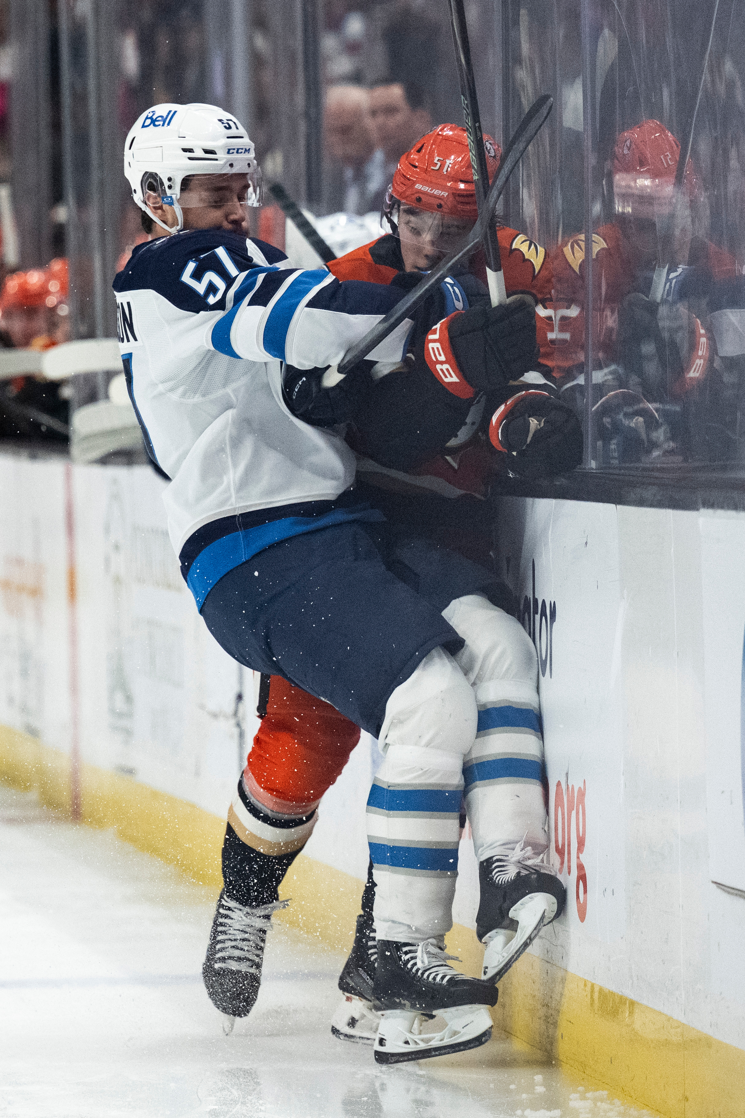 Winnipeg Jets defenseman Elias Salomonsson, left, checks Ducks defenseman Olen...