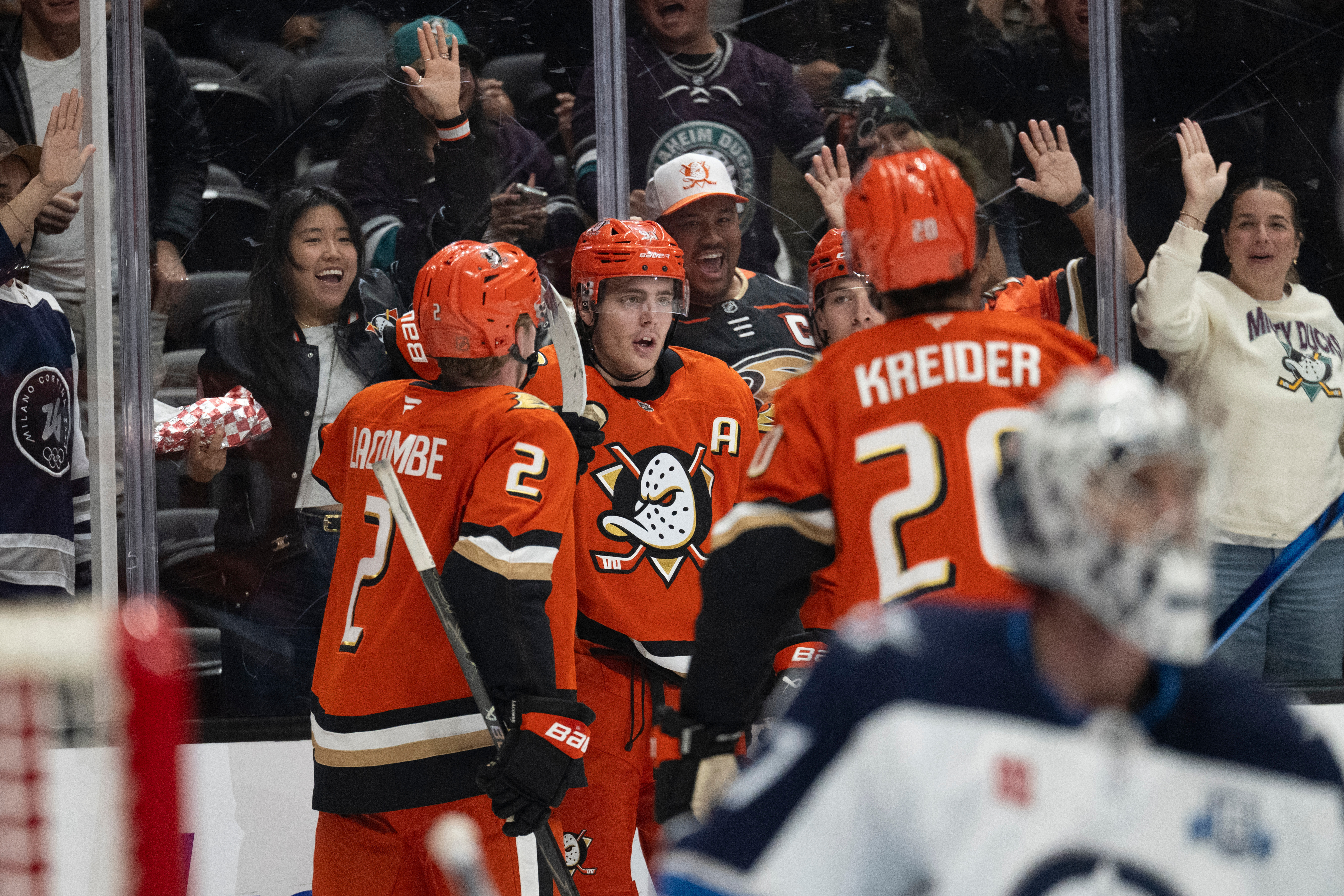 Ducks center Leo Carlsson, center, celebrates his goal with defenseman...