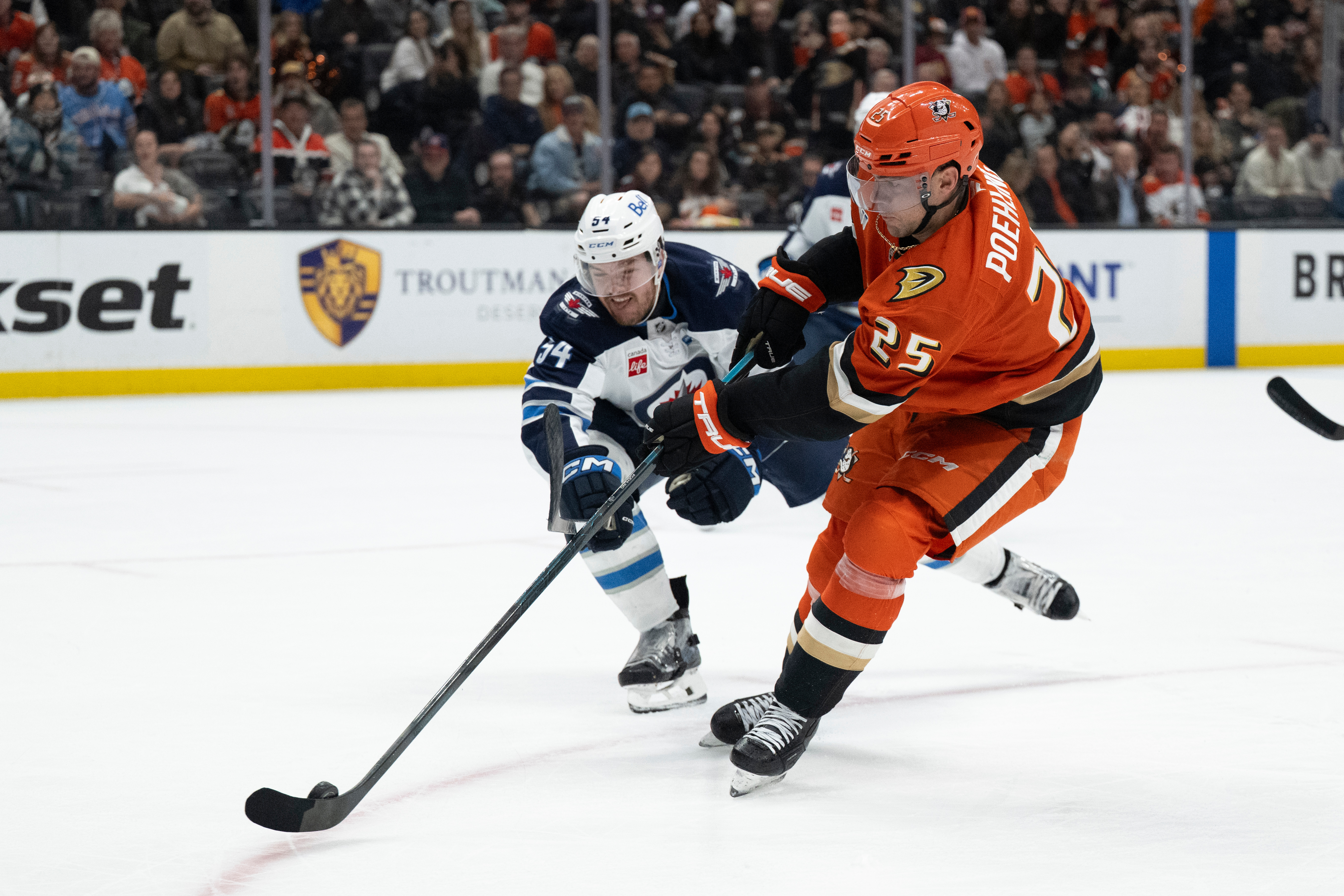 Ducks center Ryan Poehling scores past Winnipeg Jets defenseman Ville...