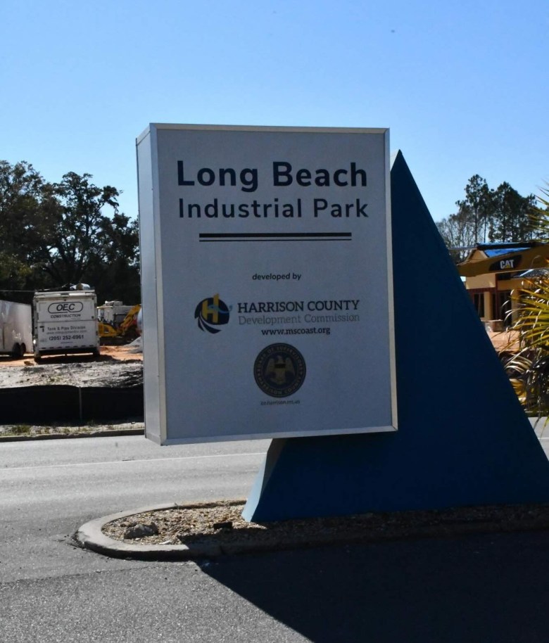 A square sign that reads “Long Beach Industrial Park.” The sign is mounted to a triangular fixture.