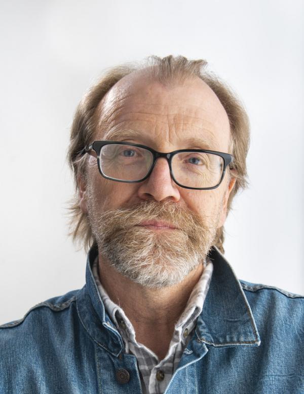 Portrait of a bearded man wearing a jean jacket