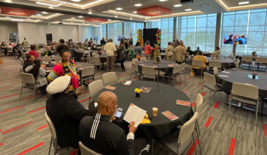 large conference room with tables and attendees socializing