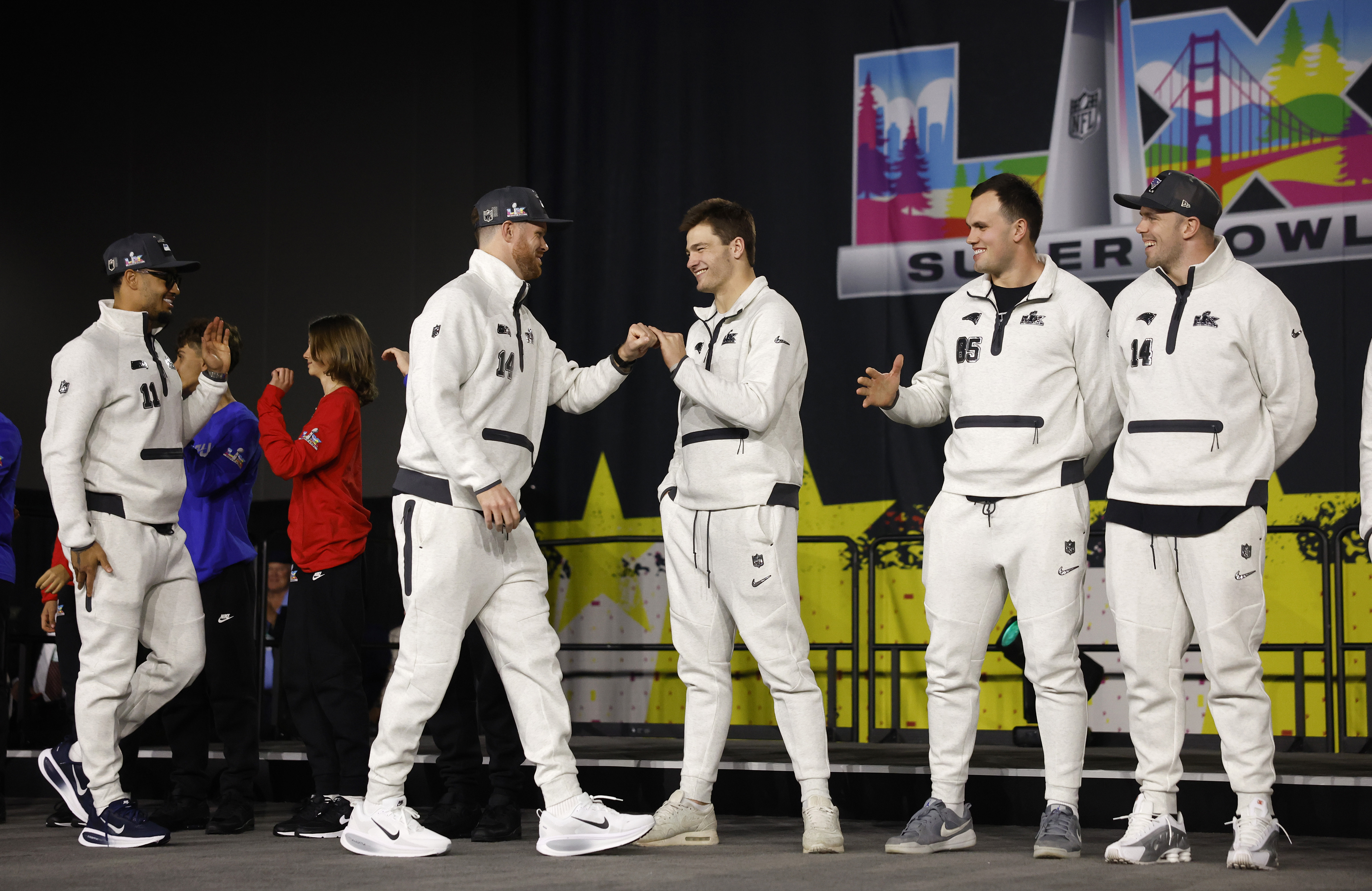 Seattle Seahawks starting quarterback Sam Darnold, left, and New England...