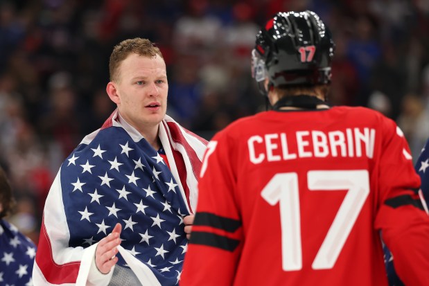 MILAN, ITALY - FEBRUARY 22: Brady Tkachuk #7 of Team United States shakes hands with Macklin Celebrini #17 of Team Canada after the team's 2-1 overtime victory in the Men's Gold Medal match between Canada and the United States on day 16 of the Milano Cortina 2026 Winter Olympic games at Milano Santagiulia Ice Hockey Arena on February 22, 2026 in Milan, Italy. (Photo by Gregory Shamus/Getty Images)