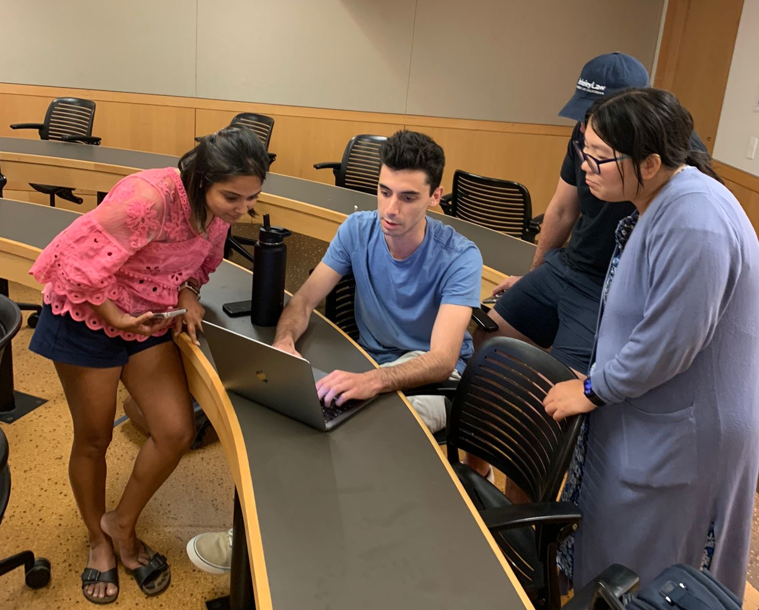 Students gathered around Belkin with laptop