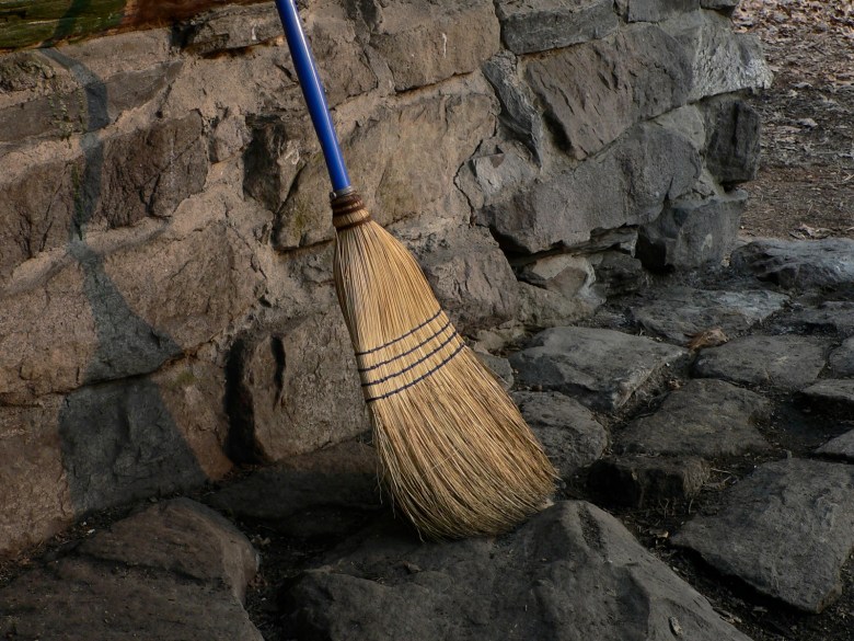Humble broom on stone wall
