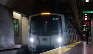 A train approaches a subway platform.