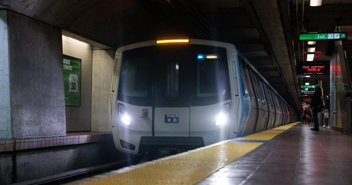 A train approaches a subway platform.