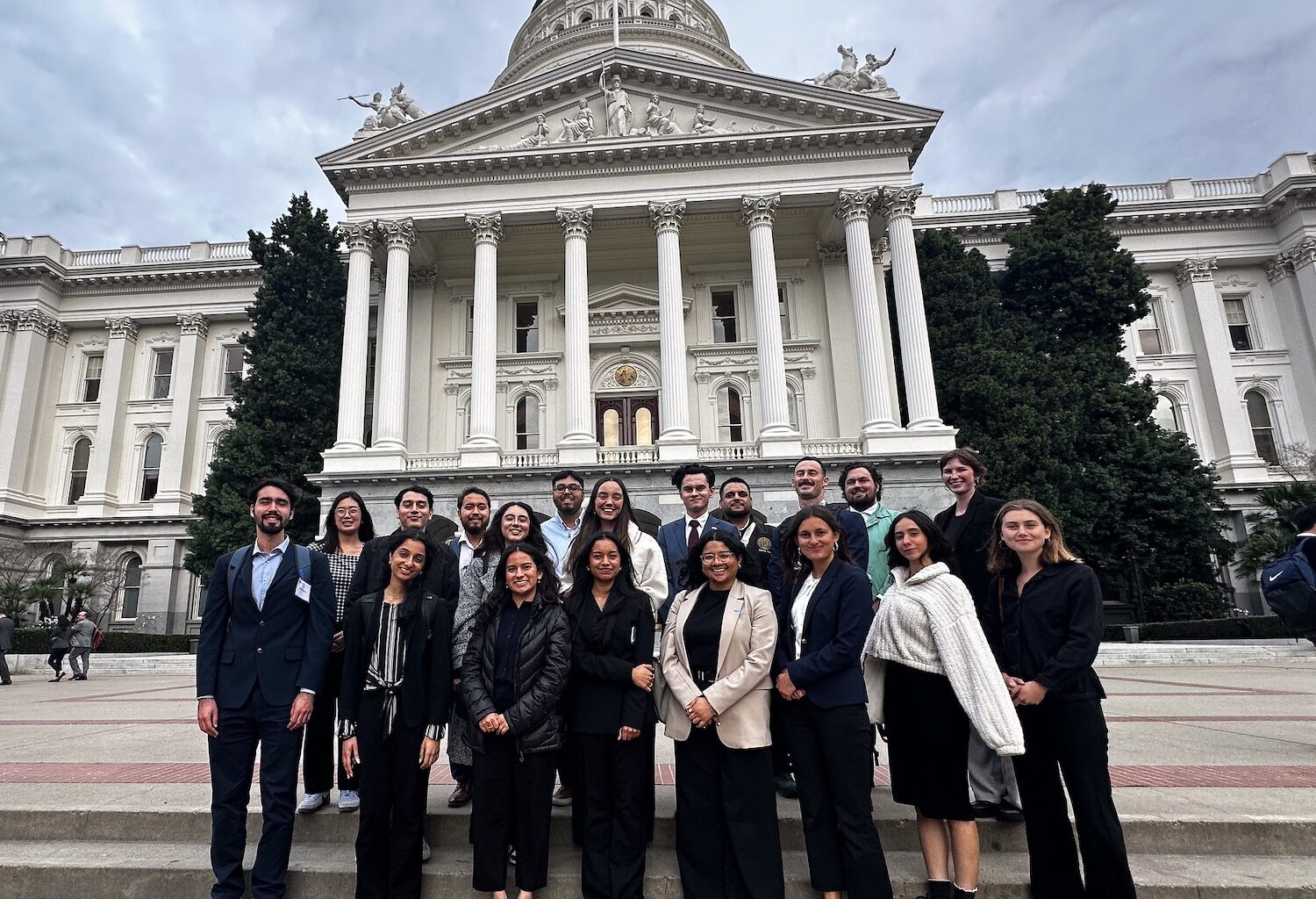 Group of people in front of ornate white building