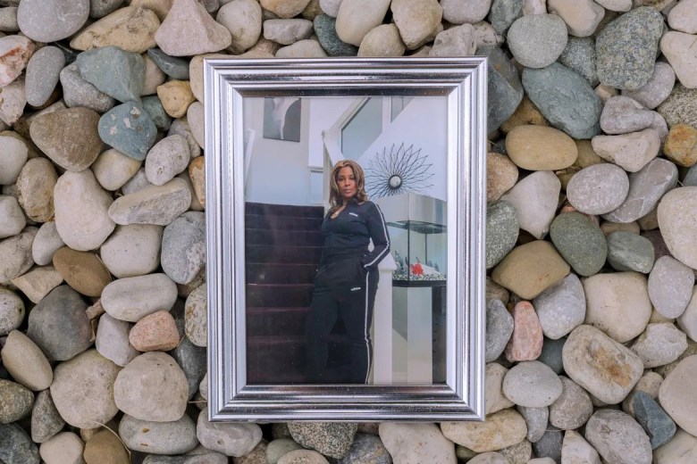 A framed photo of a person in a black tracksuit stands on a staircase, surrounded by smooth river rocks. The tone is casual and reflective.