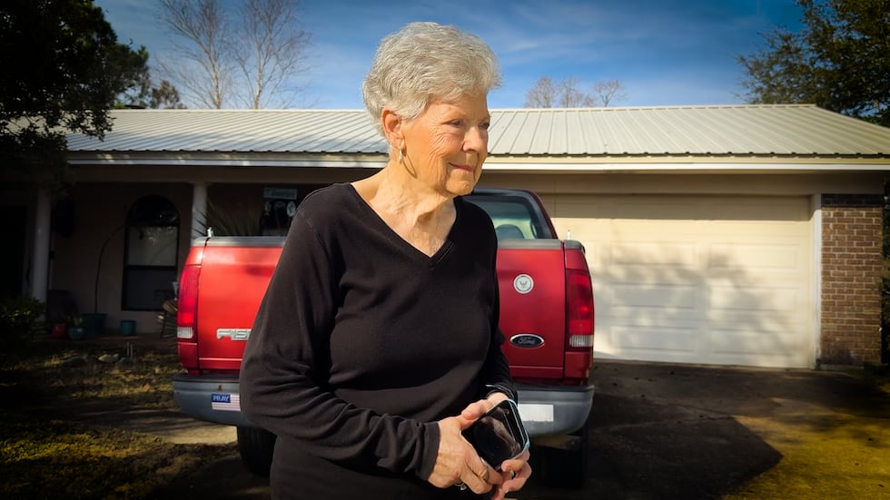 June Gautier walking to her car parked outside her Long Beach home.