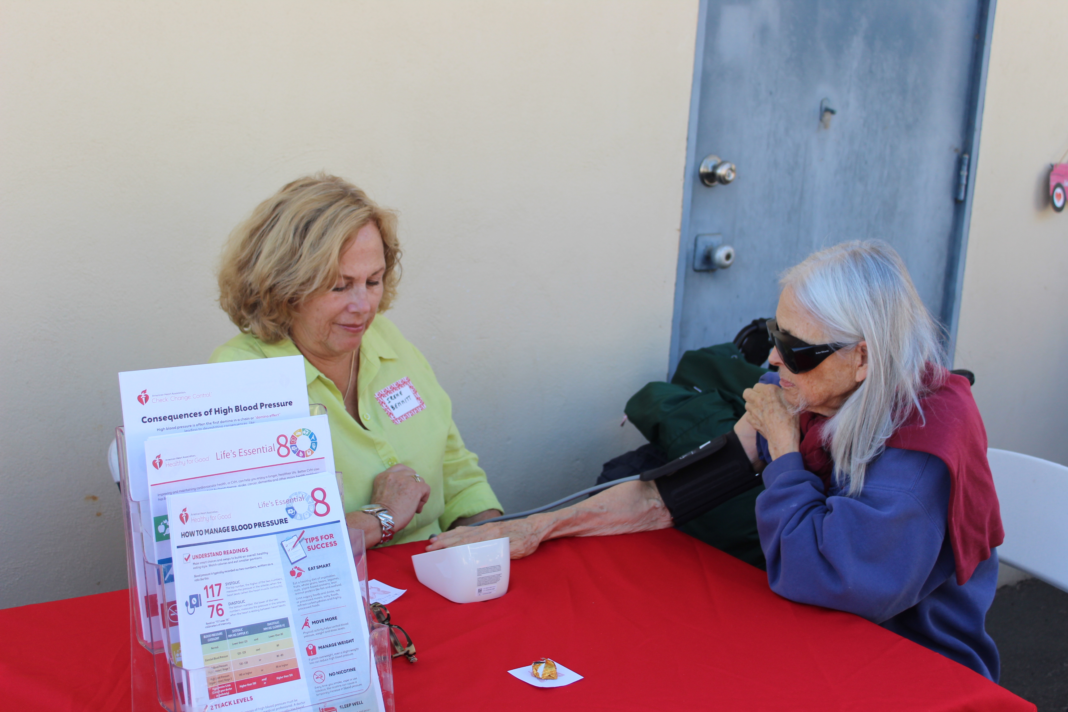 Eleanor receives a blood pressure screening from Irene Bennitt as...