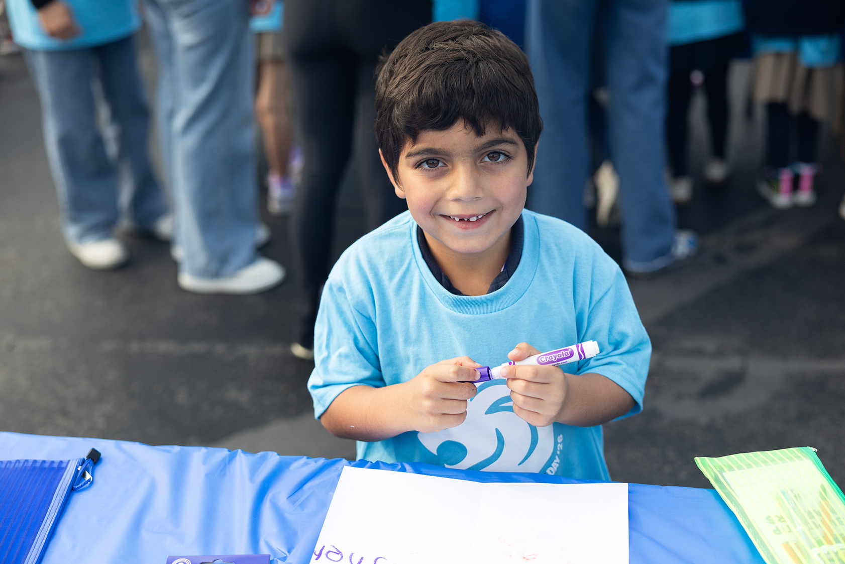 Asher writes a card of encouragement (Jon Clark)