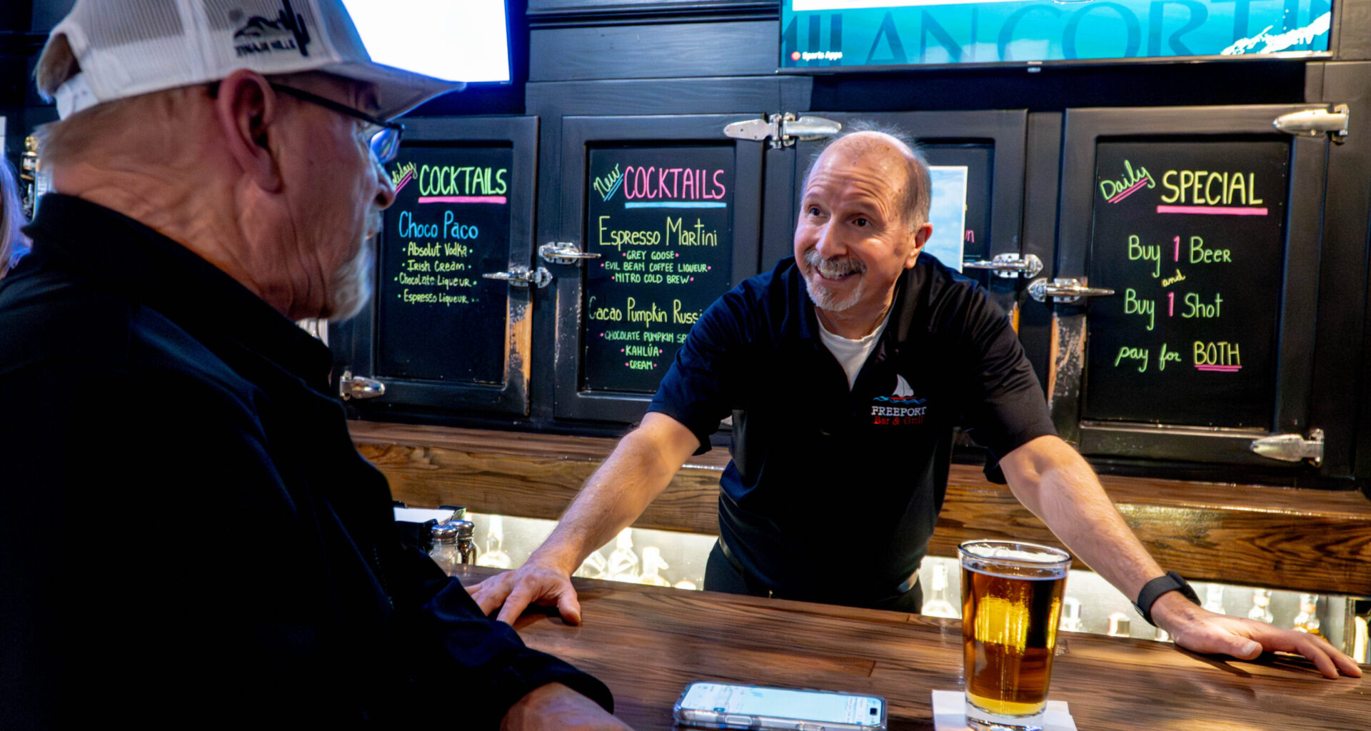 Bartender talking to customer.