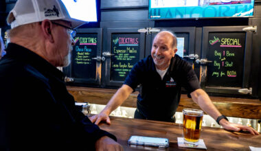 Bartender talking to customer.