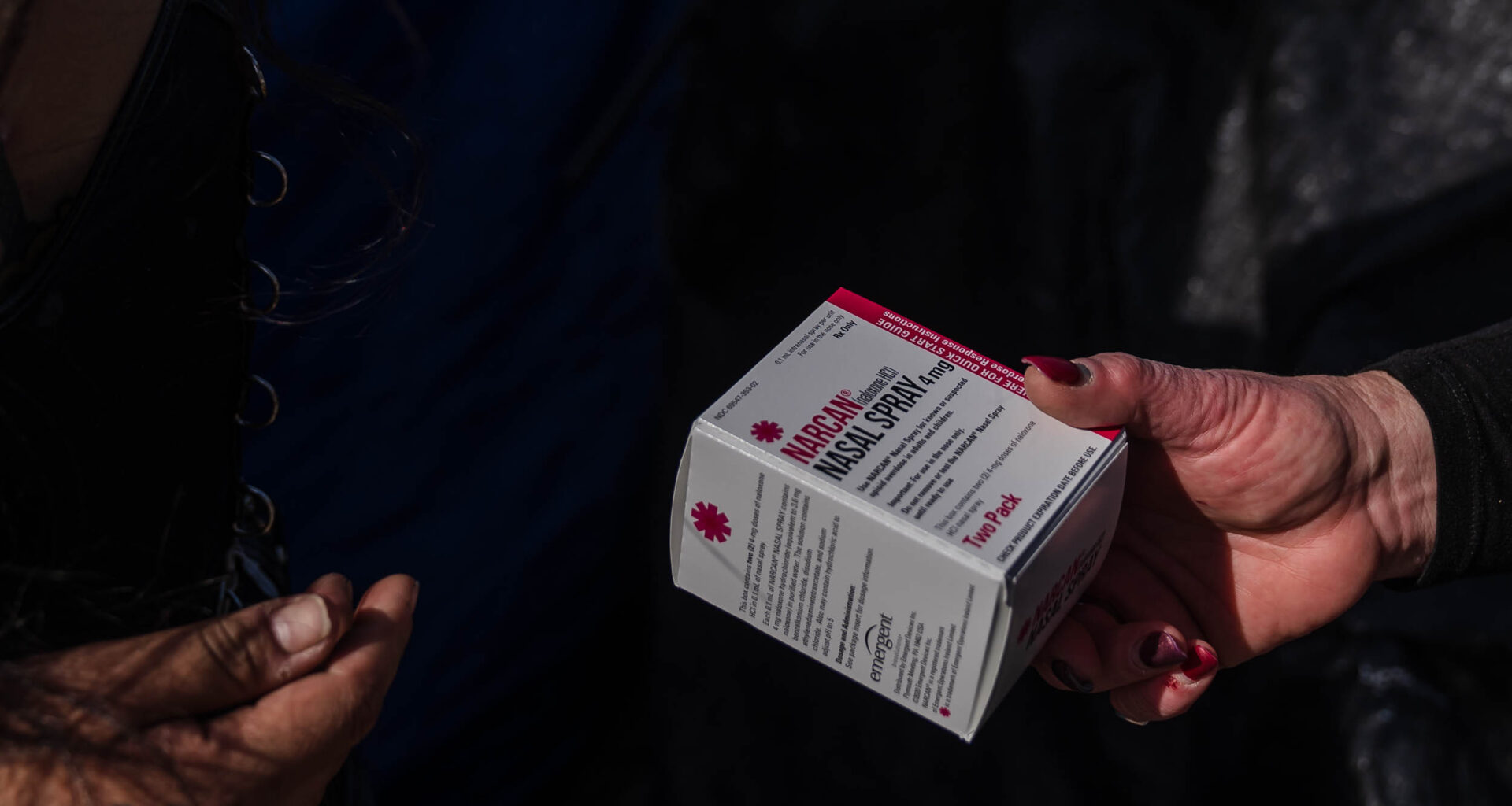 Tara Stamos-Buesig from the Harm Reduction Coalition hands out Narcan Nasal Spray to people living in a homeless encampment in downtown on Nov. 11, 2022.
