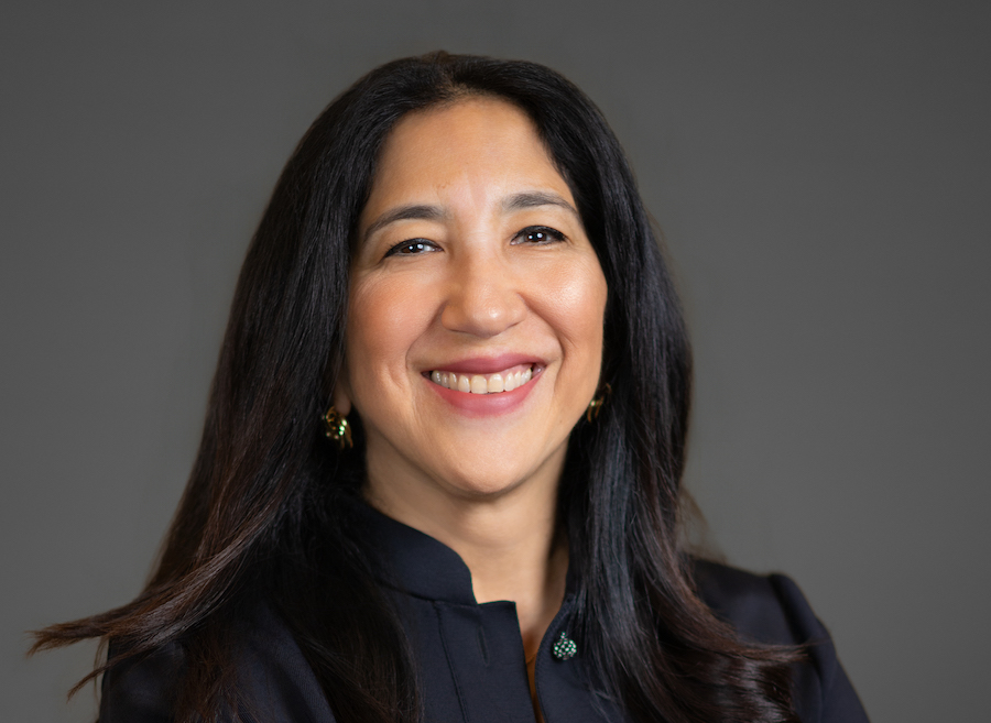 woman with long hair wearing a black suit
