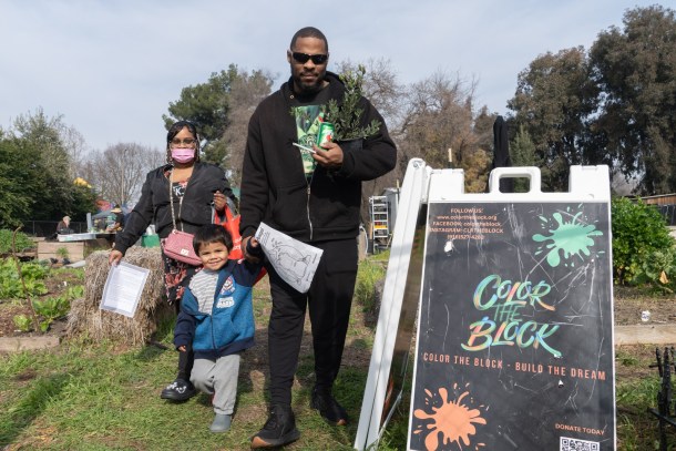 Kokoa and Tim accompany Josiah, 2 at the Color the Block event. Roberta Alvarado, OBSERVER
