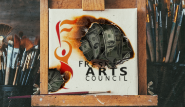 a smoldering painting with money behind the hole