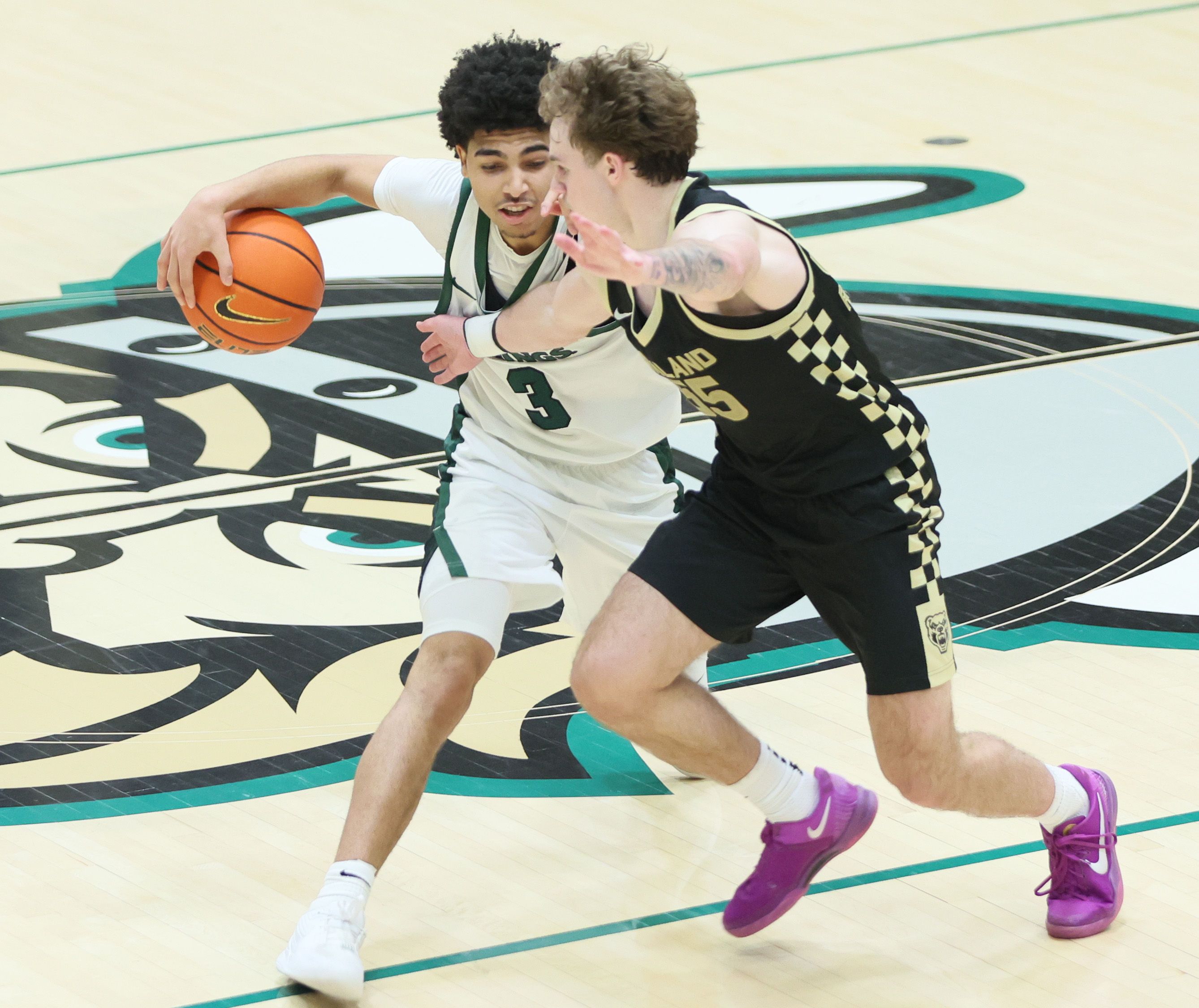 Cleveland State Vikings guard Tre Beard avoids the defense of Oakland Golden Grizzlies guard Brody Robinson as he dribbles the basketball up court in the second half.  