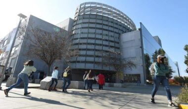Students and visitors come and go at the Fresno State Library.