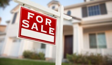For sale home sign in front of a new construction home.