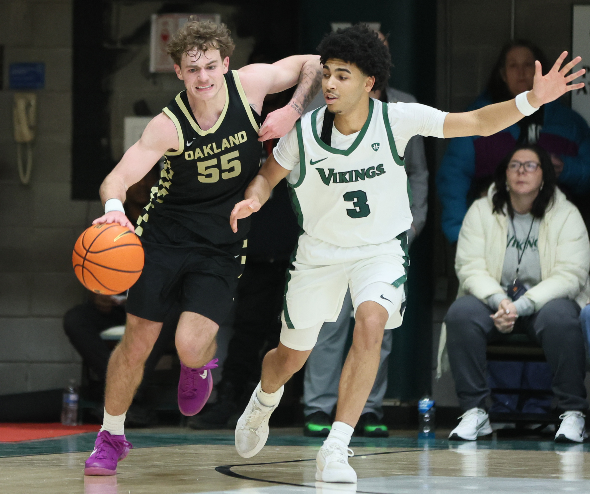Oakland Golden Grizzlies guard Brody Robinson works his offensive dribble guarded by Cleveland State Vikings guard Tre Beard in the first half.