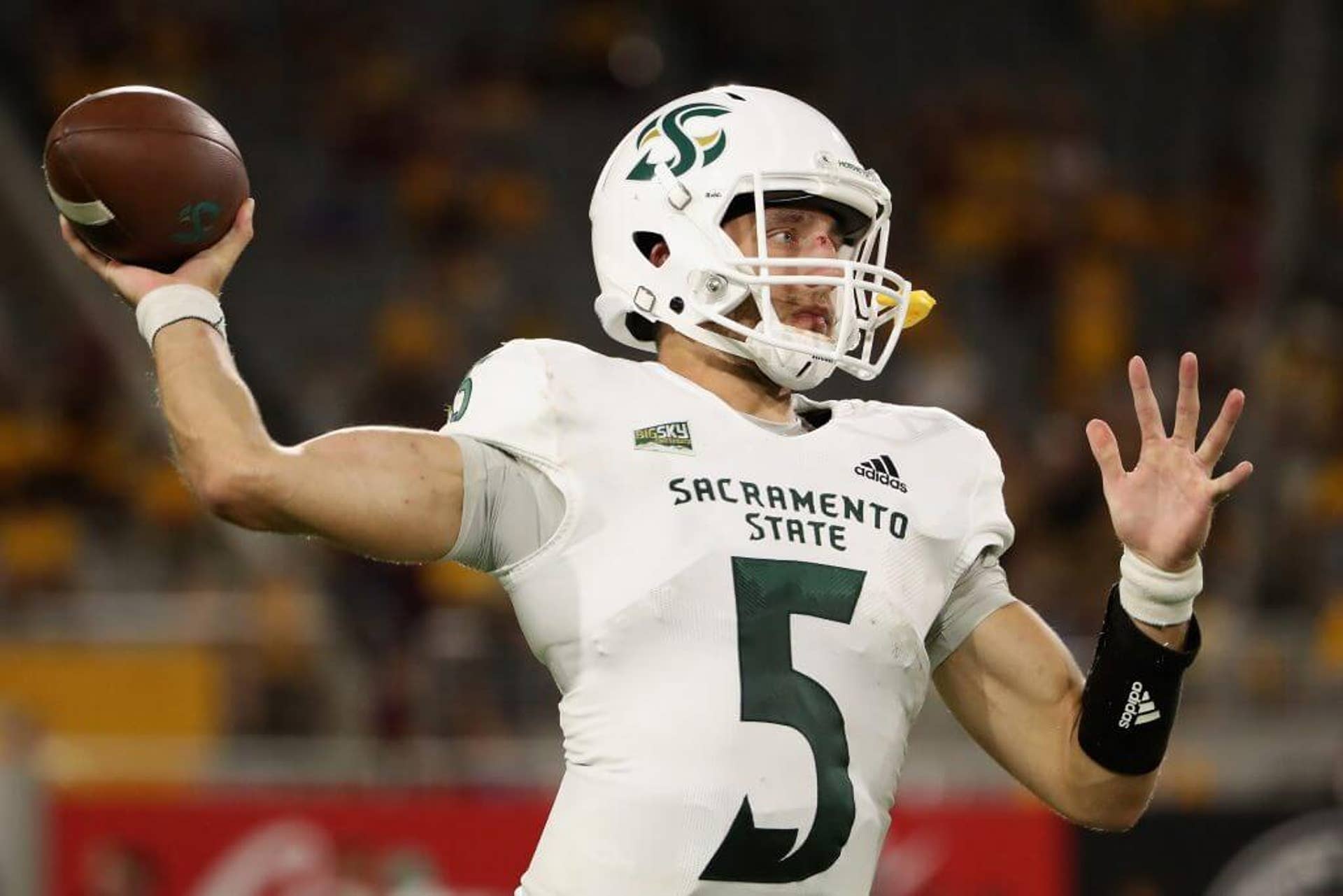 Sacramento State quarterback Kevin Thomson cocks his right arm back to throw a football during warm-ups at Sun Devil Stadium.