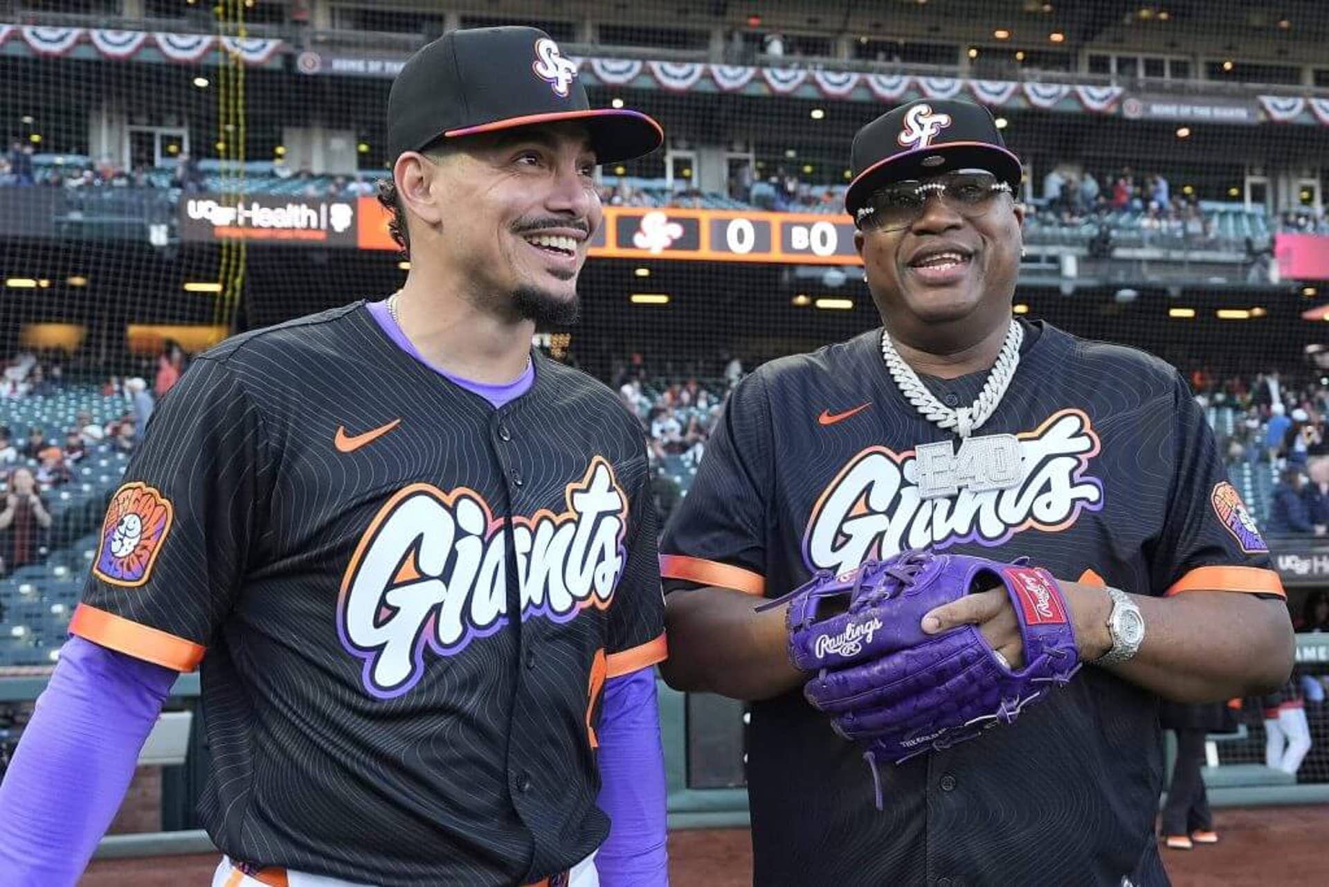 E-40 (right) chats with San Francisco Giants shortstop Willy Adames before the start of an April 8, 2025, game at Oracle Park. The rapper threw out the ceremonial first pitch, with Adames catching.