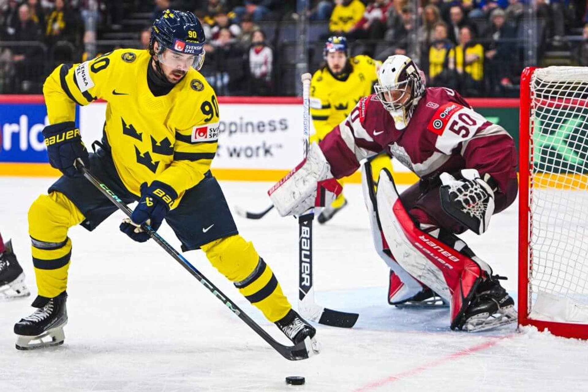 Sweden forward Marcus Johansson controls the puck in front of Latvia goaltender Kristers Gudlevskis during the IIHF Men's Ice Hockey World Championship match on May 14, 2025.