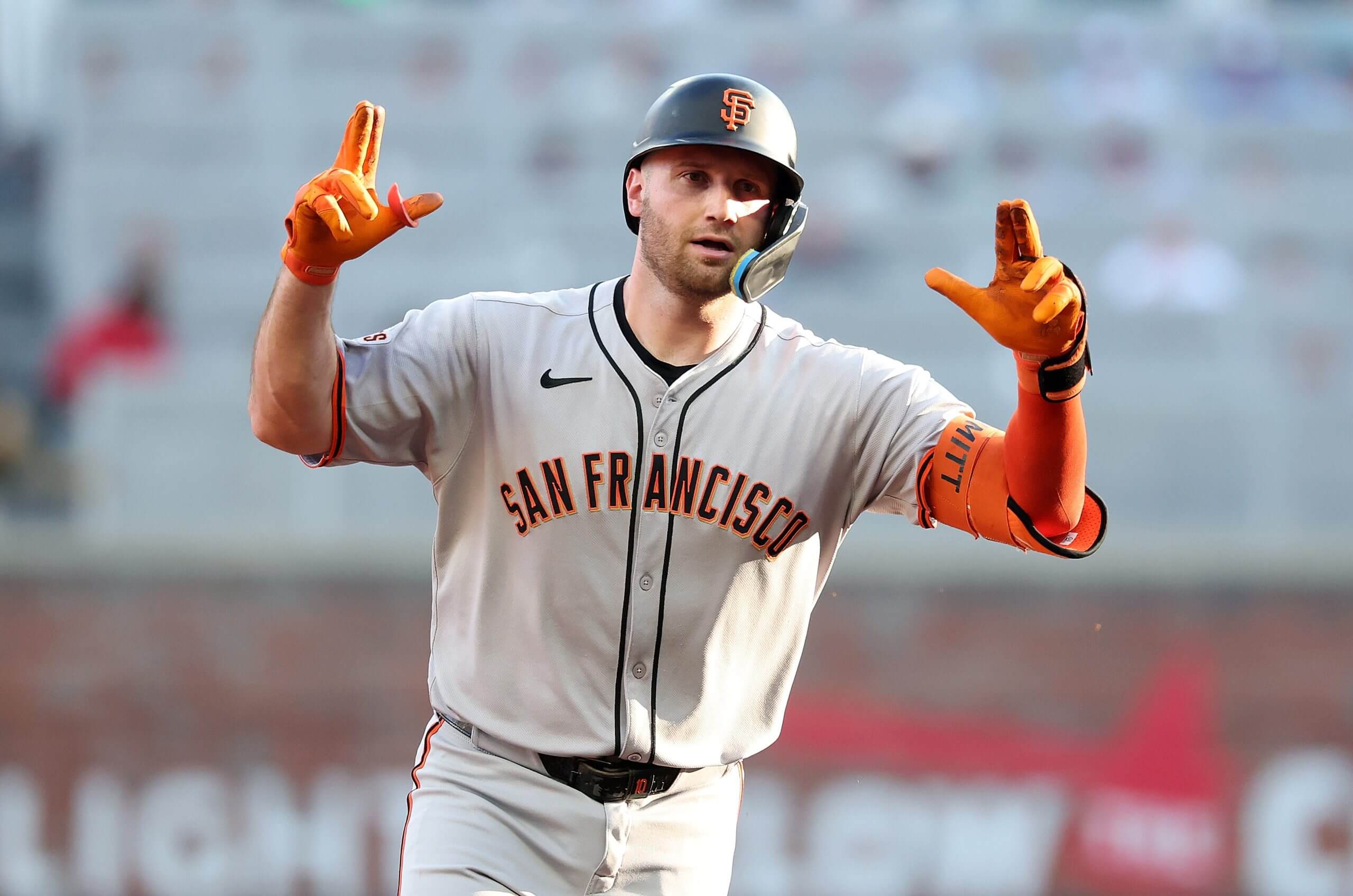 Casey Schmitt #10 of the San Francisco Giants reacts as he rounds third base after hitting a solo homer in the second inning against the Atlanta Braves at Truist Park on July 22, 2025 in Atlanta, Georgia. 