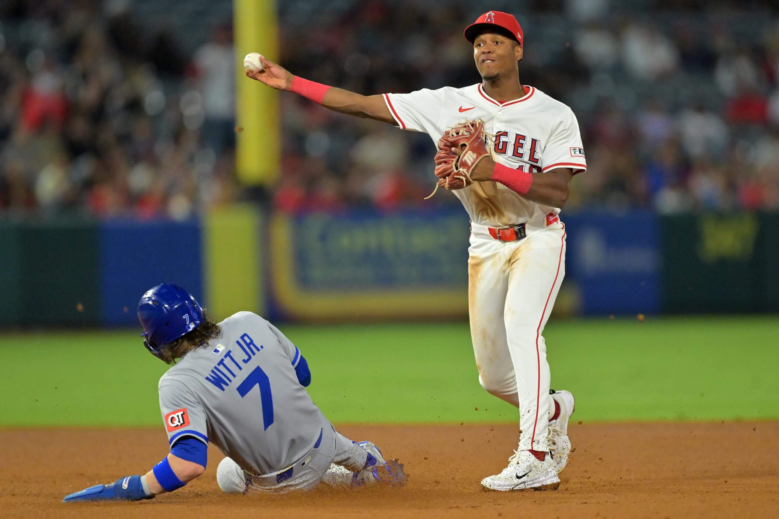 Bobby Witt Jr. #7 of the Kansas City Royals is out at second as Denzer Guzman #13 of the Los Angeles Angels throws to first in the third inning at Angel Stadium.