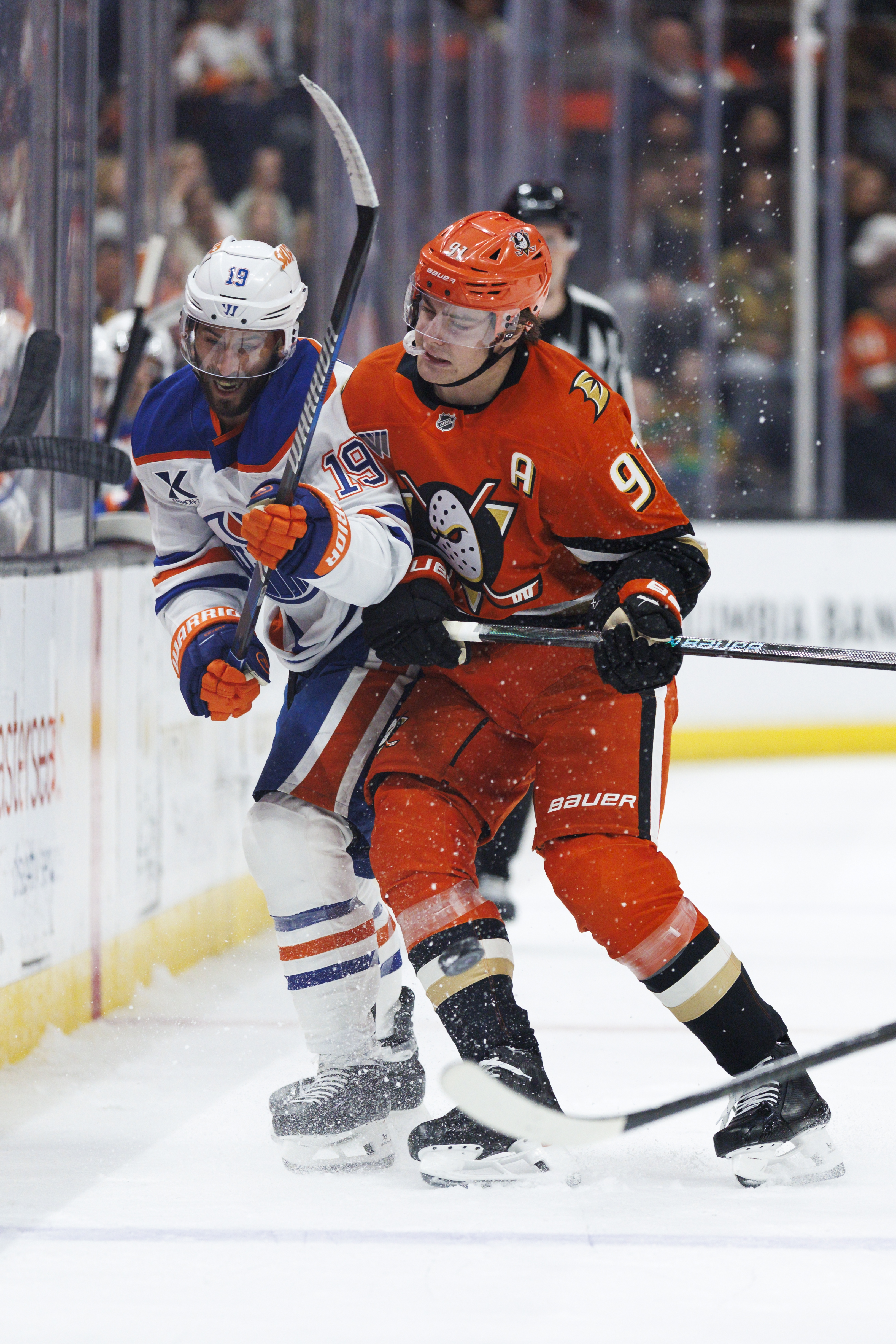 The Ducks’ Leo Carlsson, right, checks the Edmonton Oilers’ Adam...