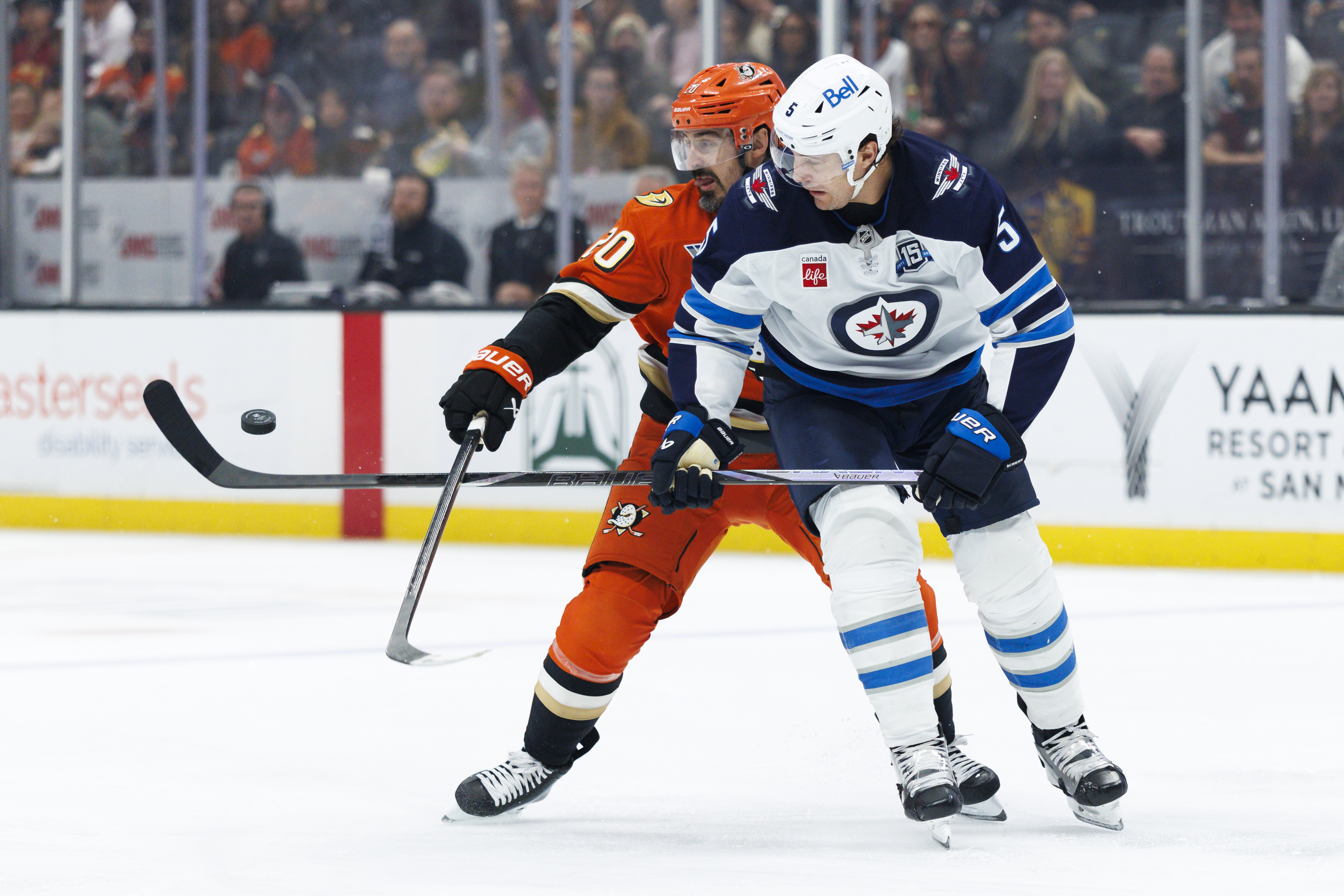 The Ducks’ Chris Kreider, left, and the Winnipeg Jets’ Luke...