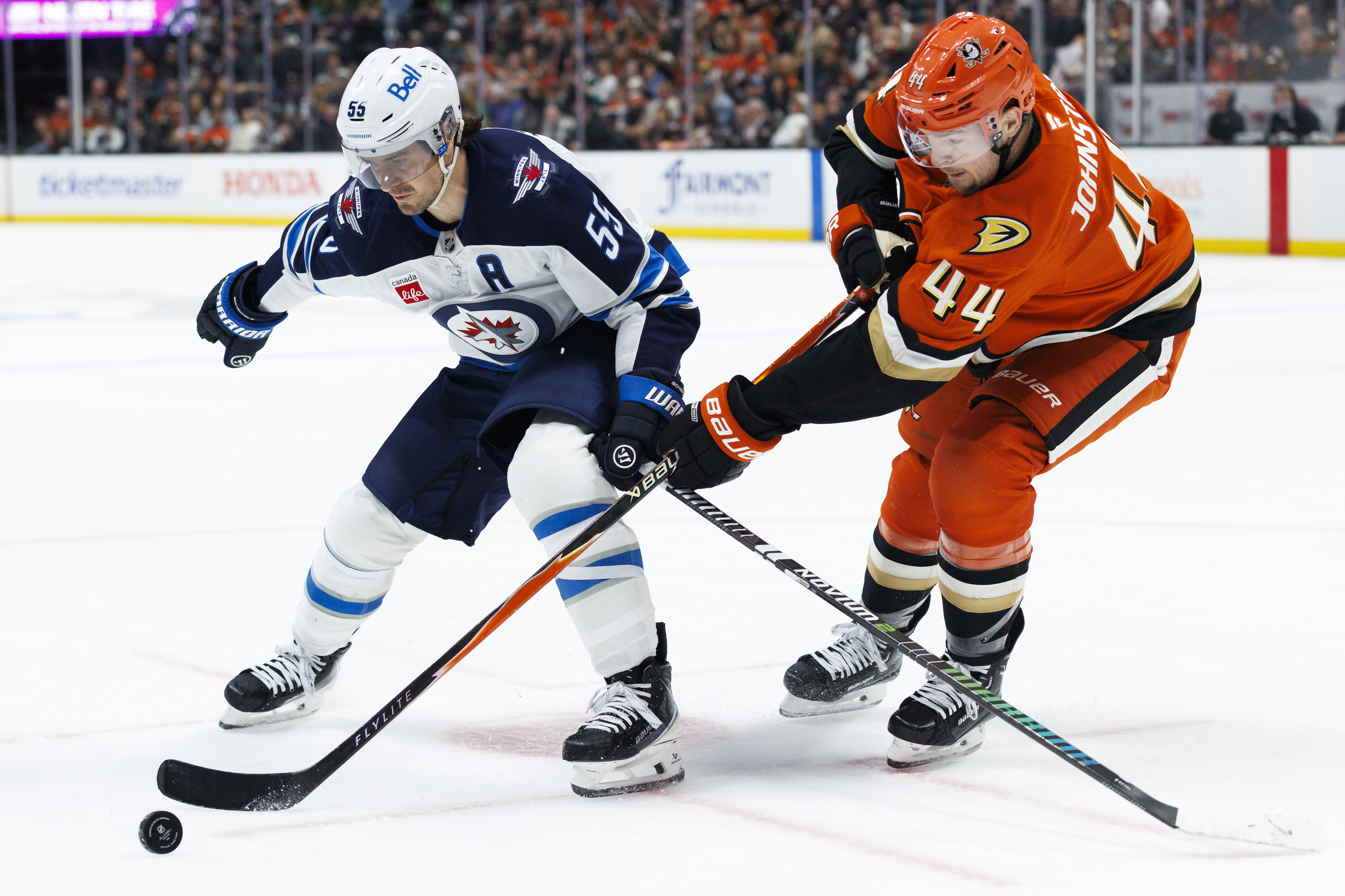 The Winnipeg Jets’ Mark Scheifele, left, and the Ducks’ Ross...