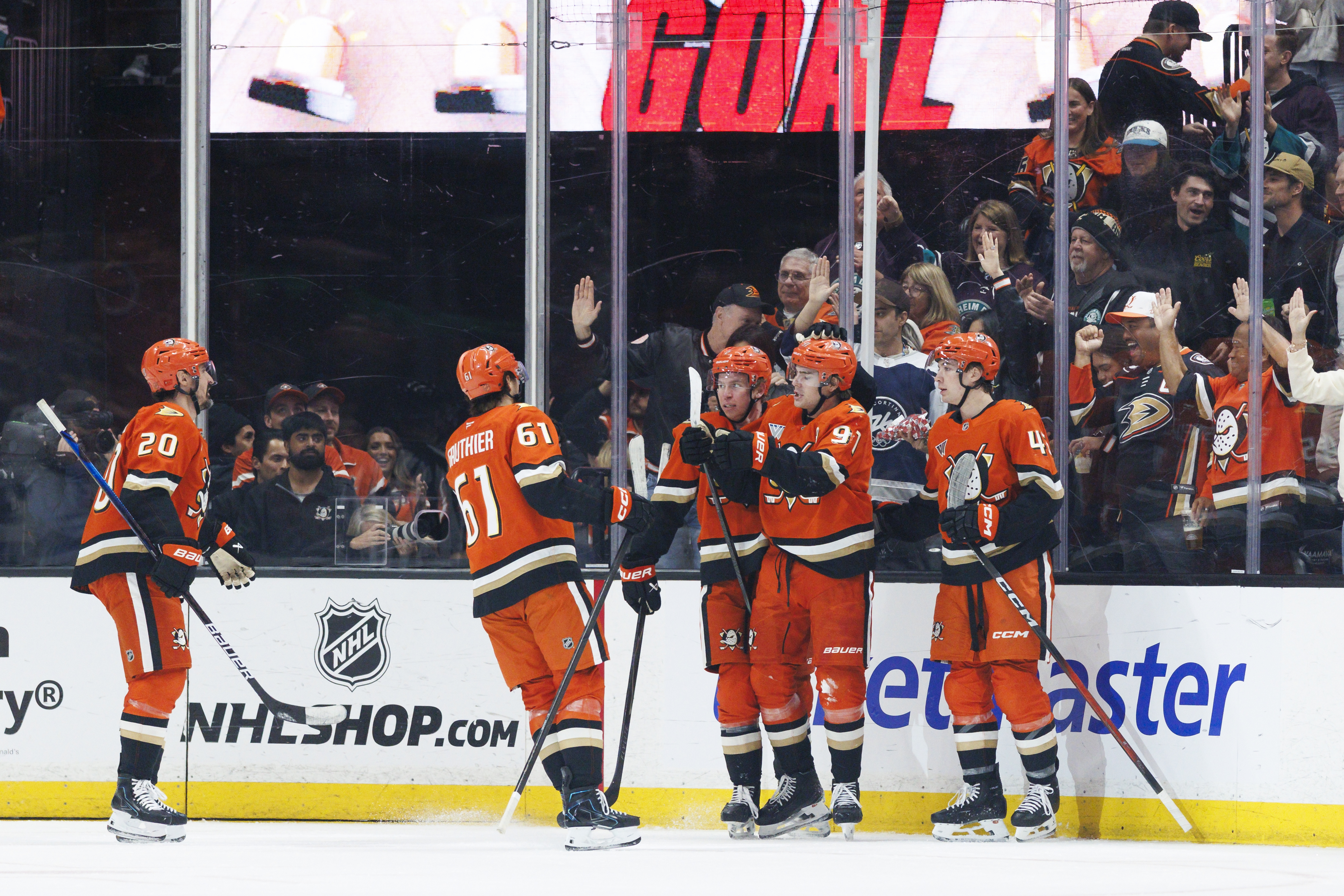 The Ducks’ Leo Carlsson (91) celebrates his goal with teammates...