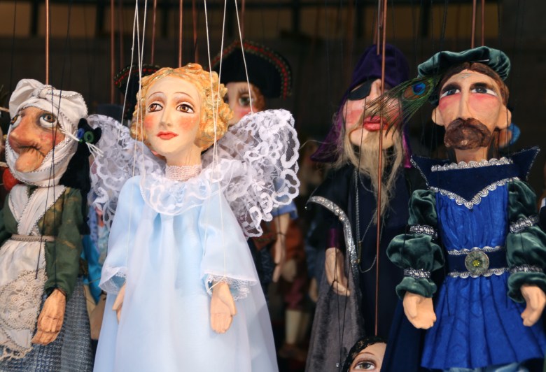 Marionettes hanging from their threads.
